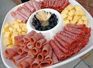 Нарезку можно оформить, свернув тонко порезанные мясо и колбасу в трубочки, а в центр блюда поставить шпажки или зубочистки, чтобы их было удобнее брать. Нарезку можно оформить, свернув тонко порезанные мясо и колбасу в трубочки, а в центр блюда поставить шпажки или зубочистки, чтобы их было удобнее брать.