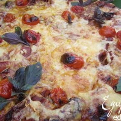 Пицца с вяленым мясом и запеченными помидорами.